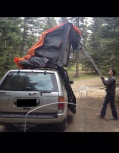 Using the ladder as a lever to close the tent.