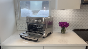 Cuisinart Air Fryer and Toaster sitting on the counter with it's front door open.