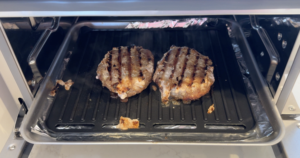 Close up of 2 burgers cooked inside the Cuisinart Air Fryer.