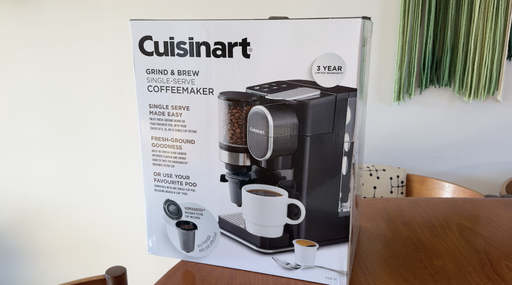 Cuisinart Grind & Brew Coffeemaker in the box sitting on a table.