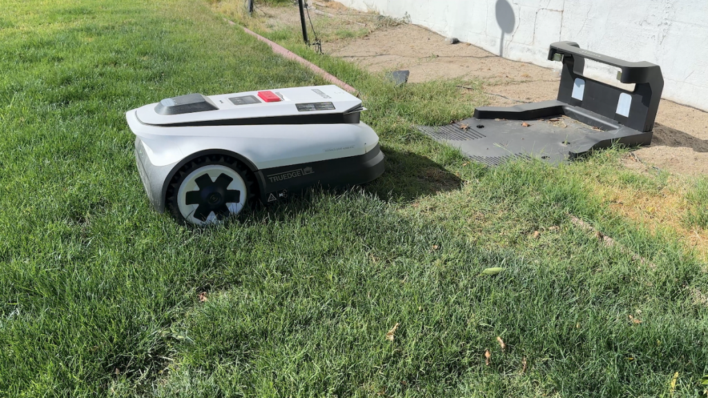Robot lawnmower backing out of base station.