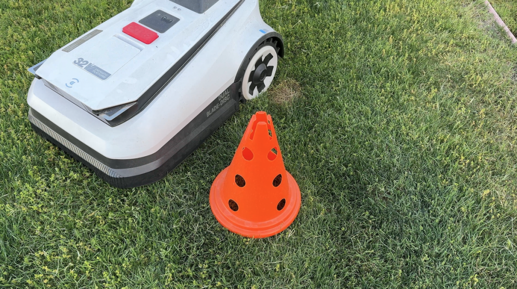 Image showing robot lawnmower avoiding pylon.