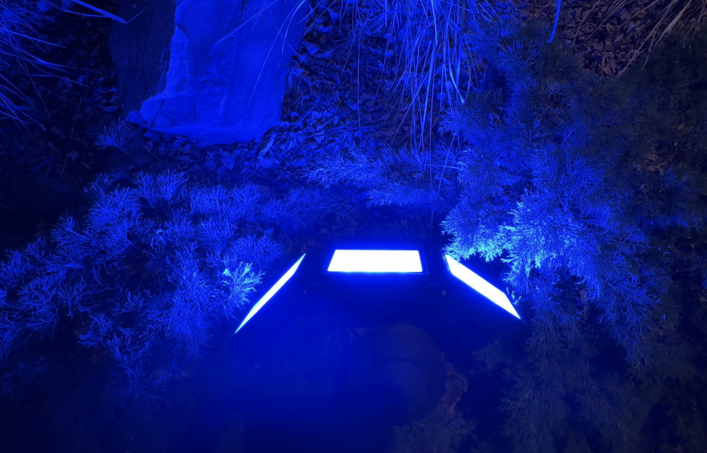 Govee Outdoor Triad Flood Lights illuminating white in a dark yard.