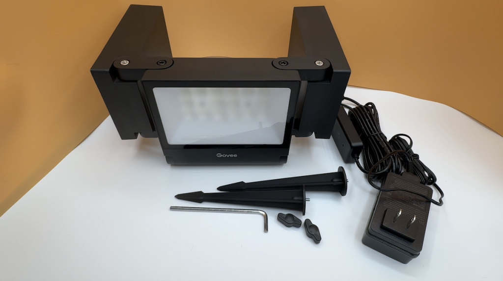 Contents of the Govee Triad Flood Lights laid out on a table.