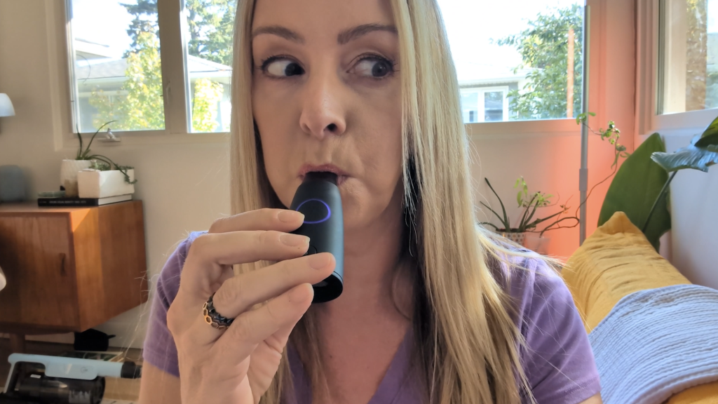Erin demonstrating blowing into the Lumen device.
