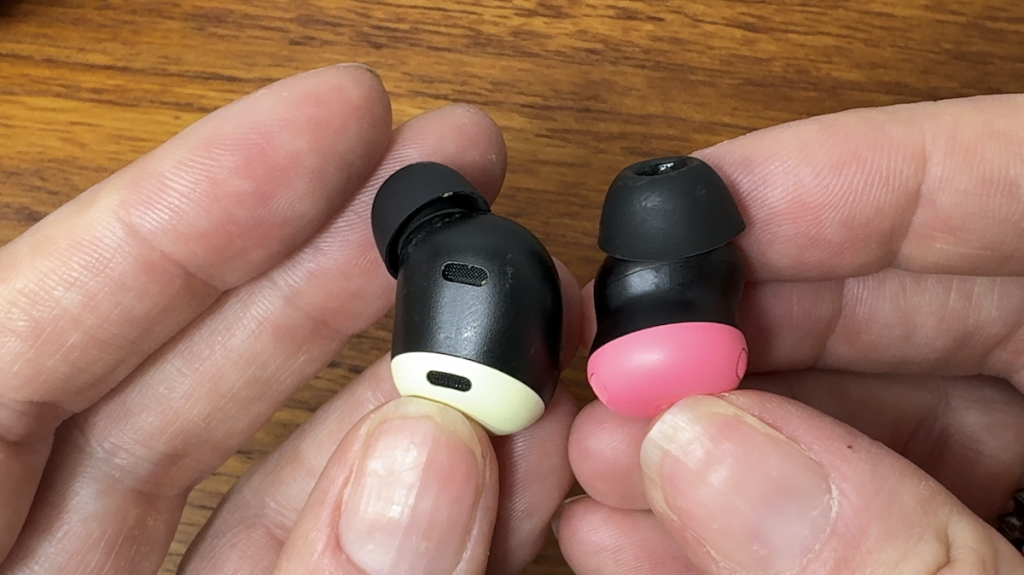 Hands holding the Pixel Bud pro 2 to compare to the 1st Gen bud.