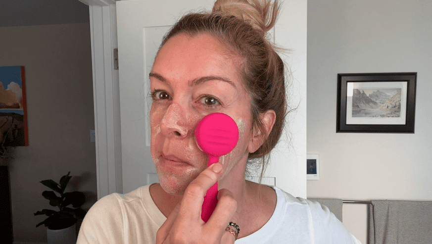 Scrubbing the face with PMD Clean.