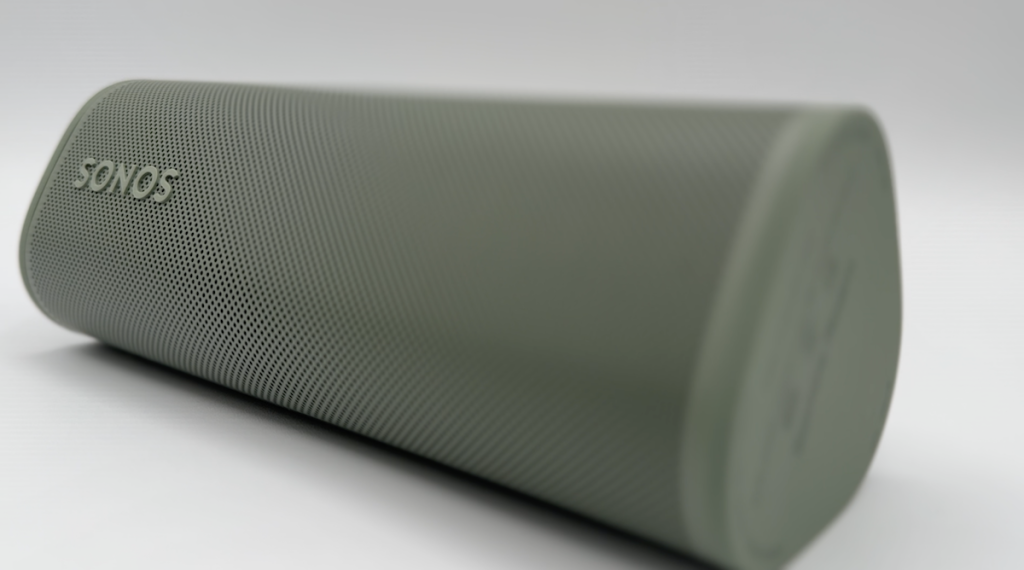 Sonos roam 2 speaker on while background.